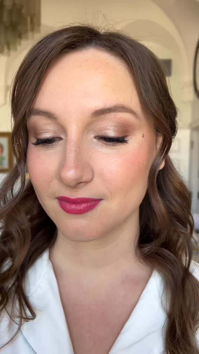 Close-up of bridal makeup with romantic waves and berry lip color