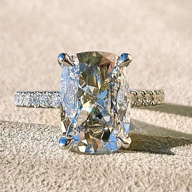 Cushion-cut diamond engagement ring with pavé band