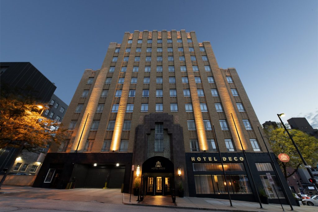 Hotel Deco Art Deco-style building at twilight with dramatic uplighting on its beige facade