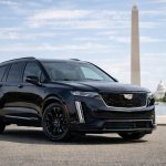 Black Cadillac Escalade on National Mall with Washington Monument and U.S. Capitol visible
