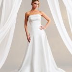 Bride in strapless A-line wedding dress with flowing train