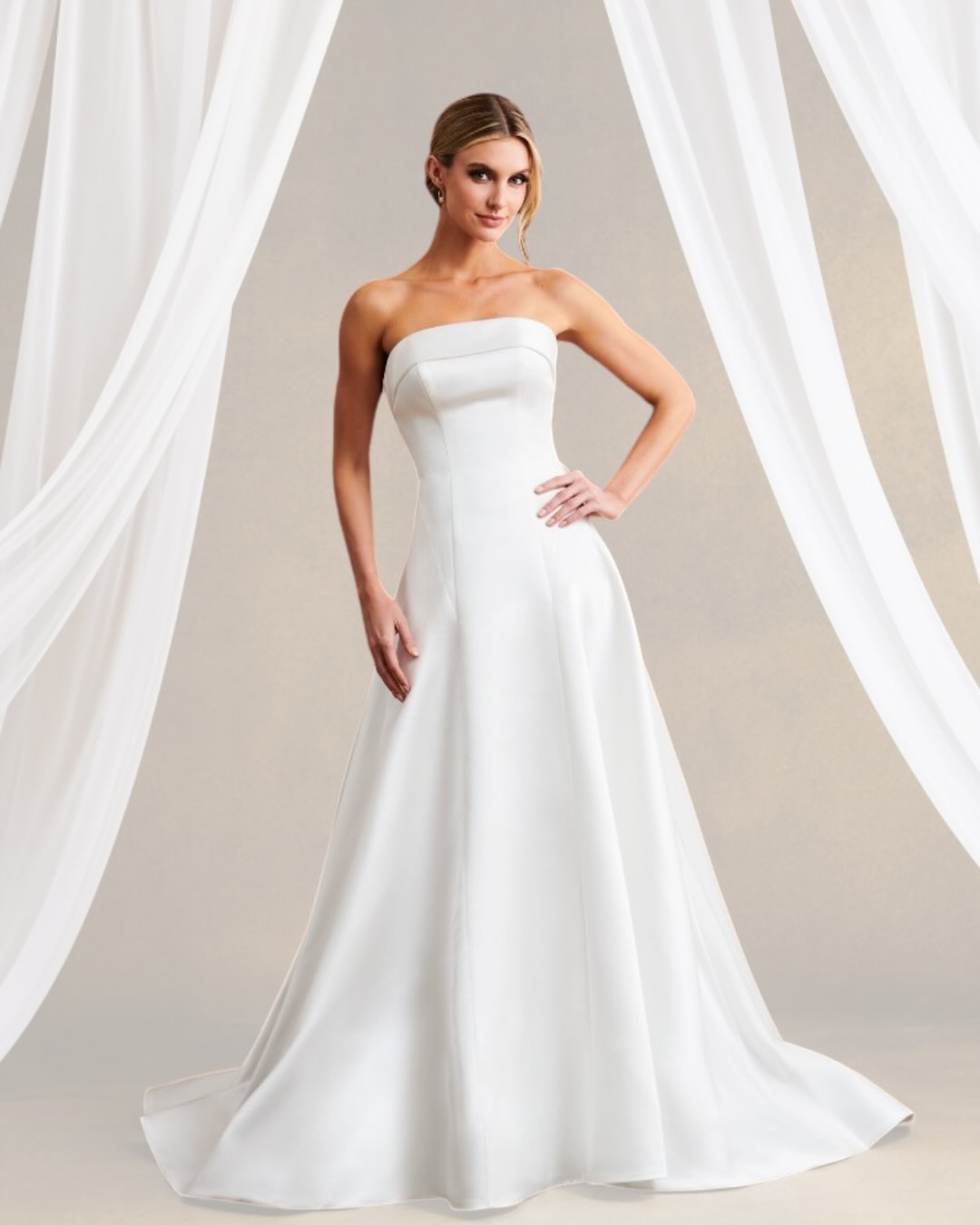 Bride in strapless A-line wedding dress with flowing train