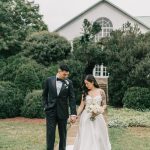Couple holding hands walking on garden pathway at Northern Virginia wedding venue