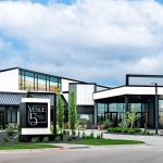 Modern white event venue building with manicured lawn in Nebraska