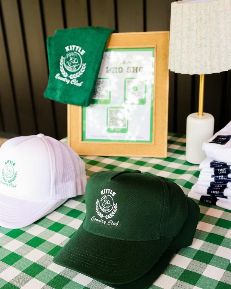 Custom Country Club themed wedding favors including embroidered caps, towels, and candles