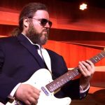 Live musician with electric guitar entertaining at wedding celebration