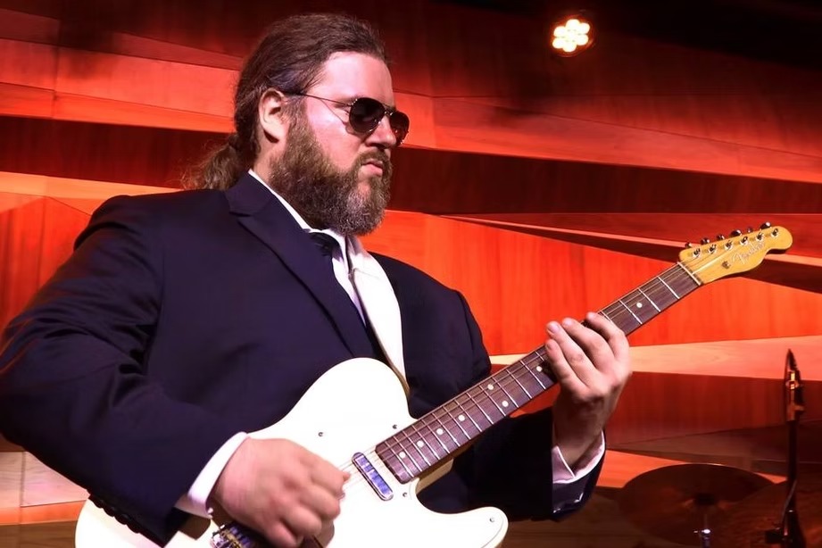 Live musician with electric guitar entertaining at wedding celebration