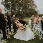 Bride and groom kiss during outdoor ceremony on Omaha Country Club grounds