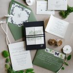 Elegant wedding invitation suite in green and navy with botanical details, calligraphy, and moss accents