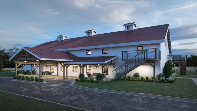 Modern white barn wedding venue with red metal roof, covered porch, exterior staircase, and landscaped grounds at dusk