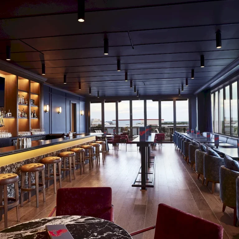 The Scarlet Hotel Nebraska bar area with dark wood tones and ambient lighting