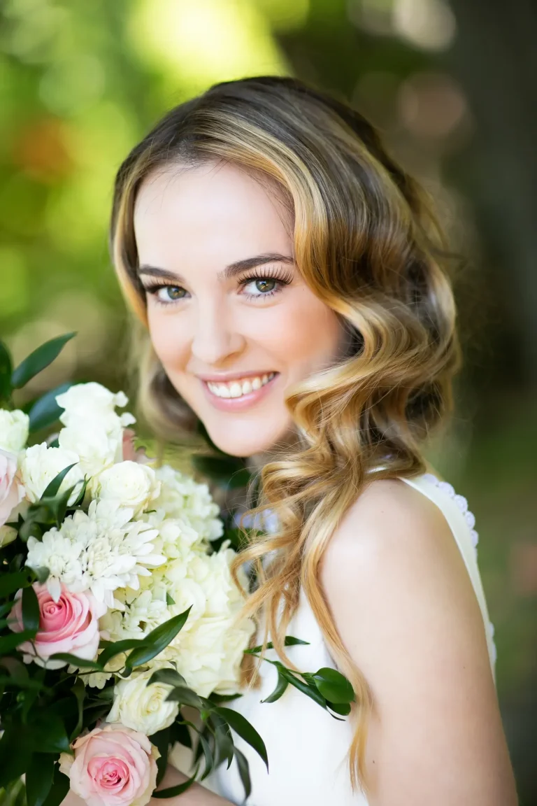 Bride with vintage-inspired Hollywood waves, natural makeup, and white rose bouquet
