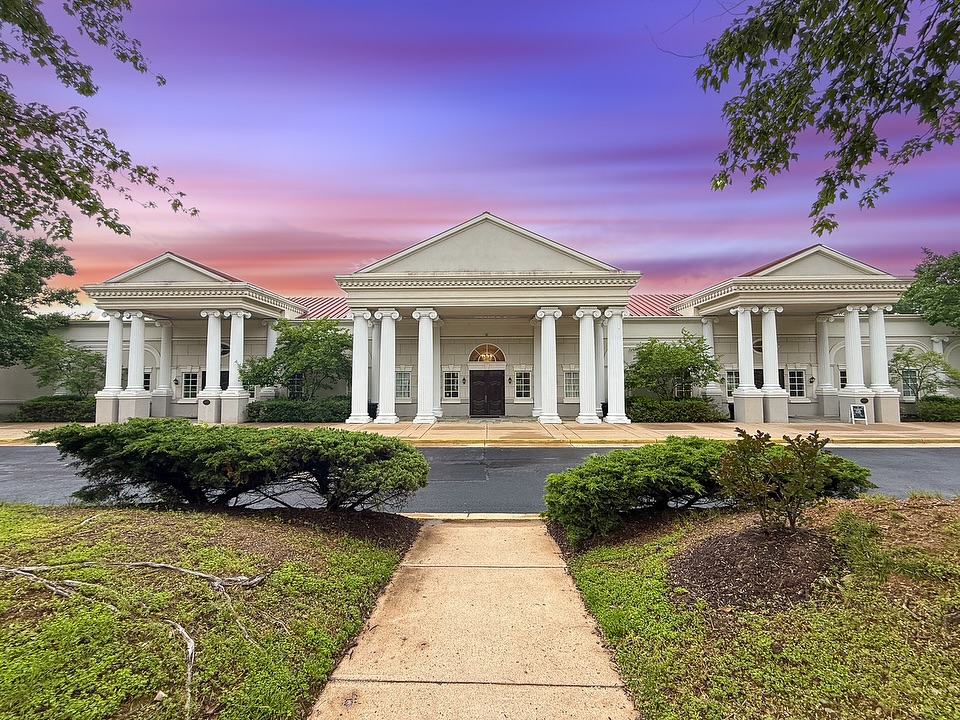 Elegant Northern Virginia wedding venue featuring white columned portico at sunset