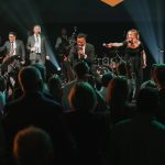 Downtown Collective band performing for enthusiastic wedding reception crowd with horn section and vocalist