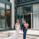 Newlyweds at modern Nebraska reception venue featuring glass walls and elegant design