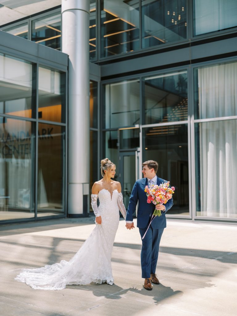 Newlyweds at modern Nebraska reception venue featuring glass walls and elegant design