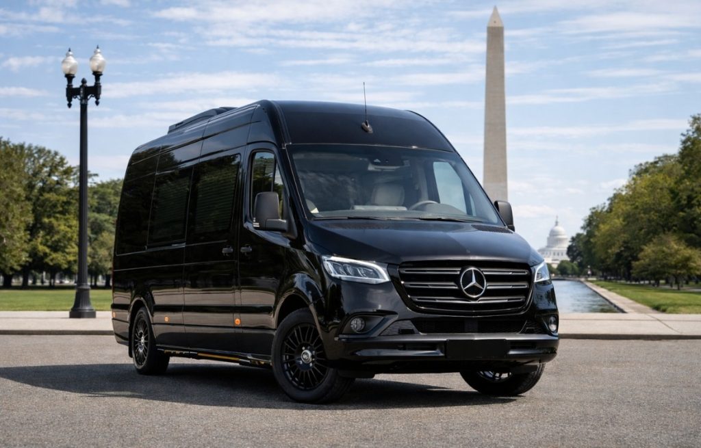 Black Mercedes luxury shuttle van on National Mall with Washington Monument and Capitol in background