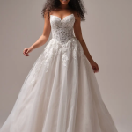 Bride in white lace ball gown wedding dress with sweetheart neckline and full tulle skirt