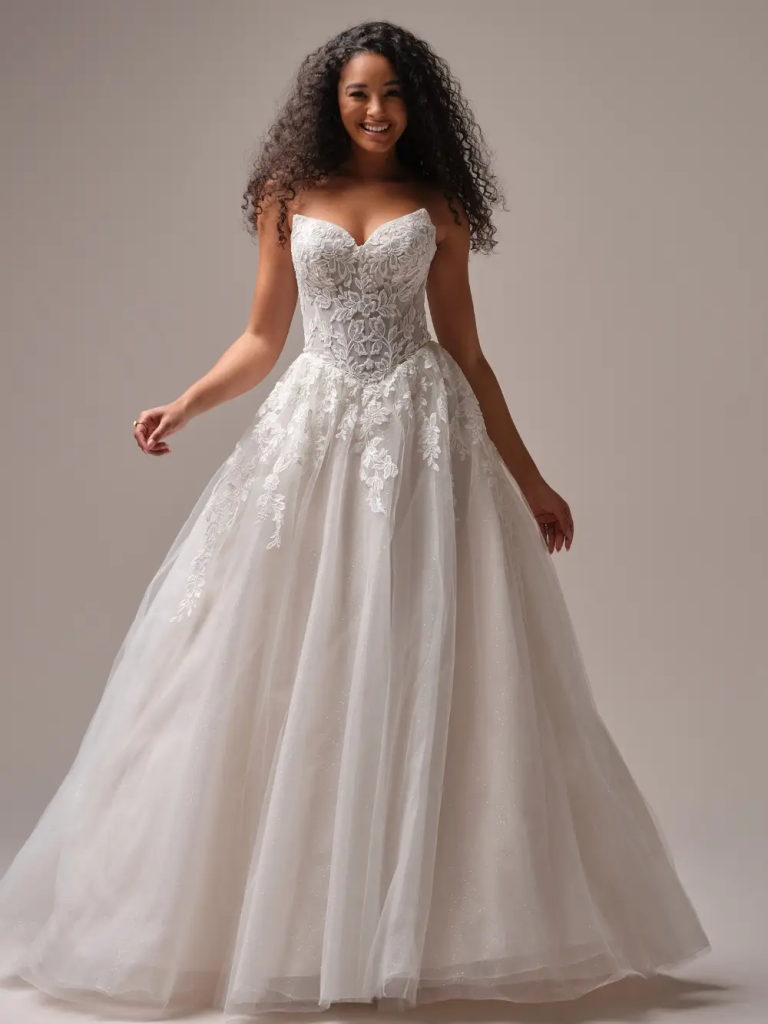 Bride in white lace ball gown wedding dress with sweetheart neckline and full tulle skirt