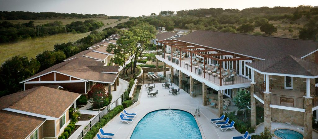 Aerial view of wedding venue with pool and outdoor reception space
