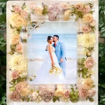 White resin picture frame decorated with preserved wedding flowers in cream, peach, and coral tones