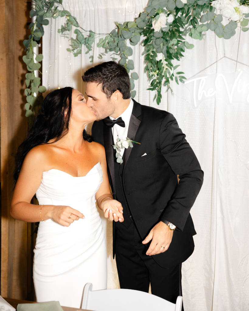 Maribelle shares a joyful moment with her bridesmaids holding spring bouquets in pink, white, and peach
