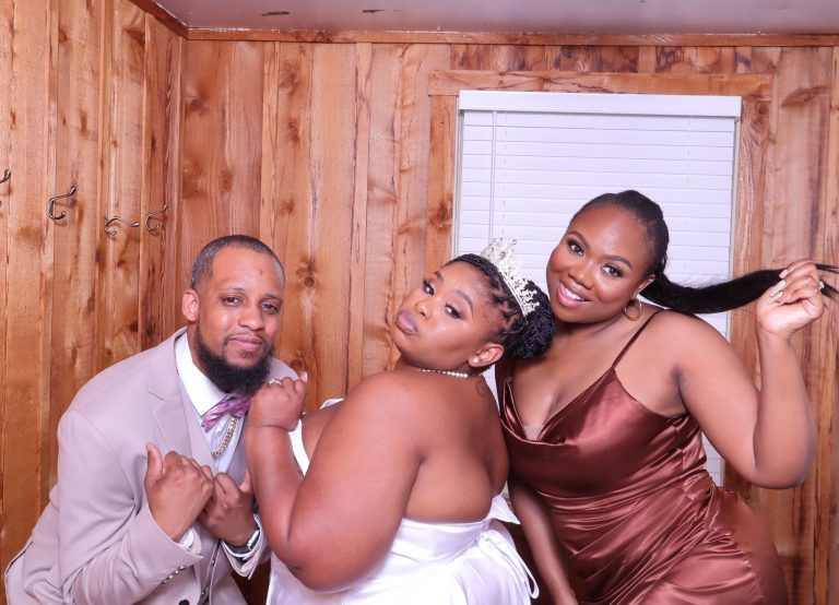 Wedding party celebrating together at photo booth