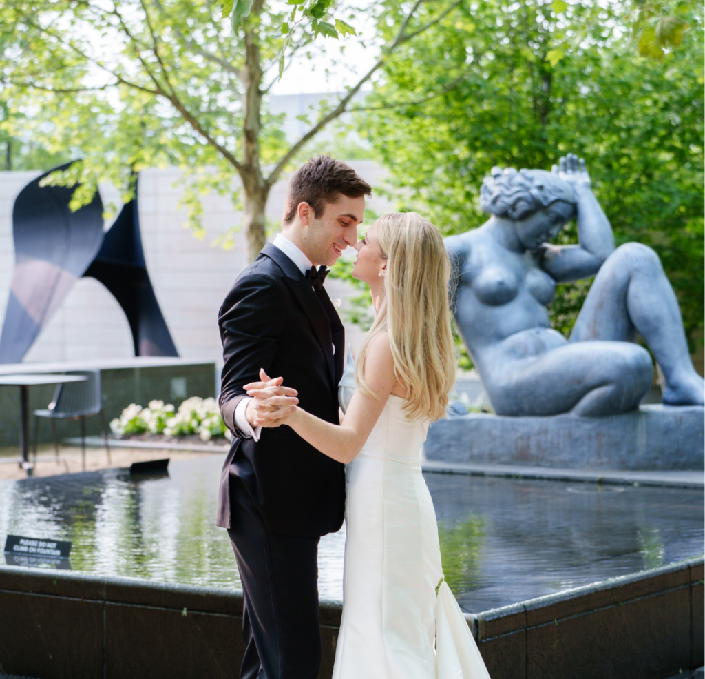 Bride in fitted gown and groom share intimate moment at Columbus Museum of Art