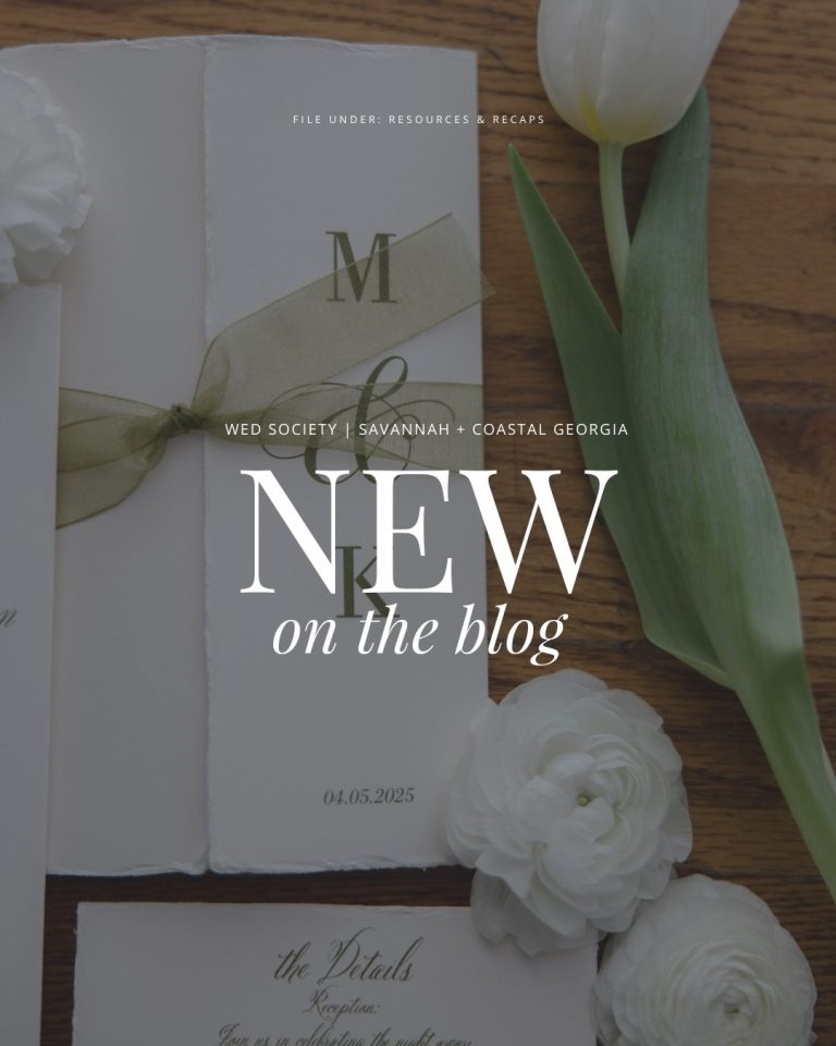 Elegant wedding invitation suite with white ranunculus flowers and ribbon on wooden table