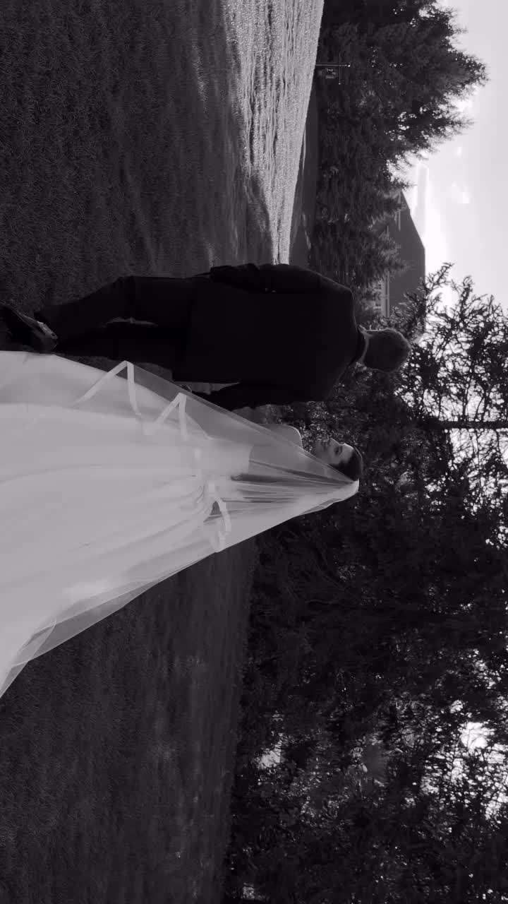 Bride and groom walking hand-in-hand along a tree-lined waterway in Columbus