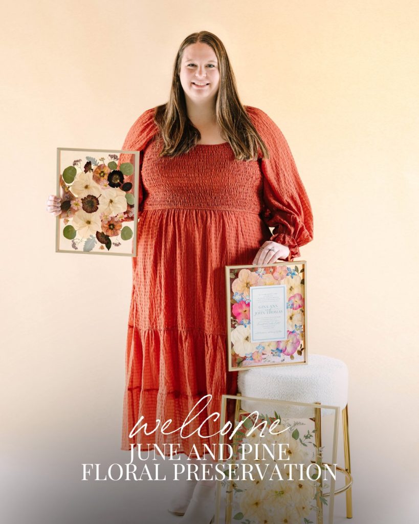 Wedding planner displaying preserved floral arrangements in gold frames from June and Pine Floral Preservation