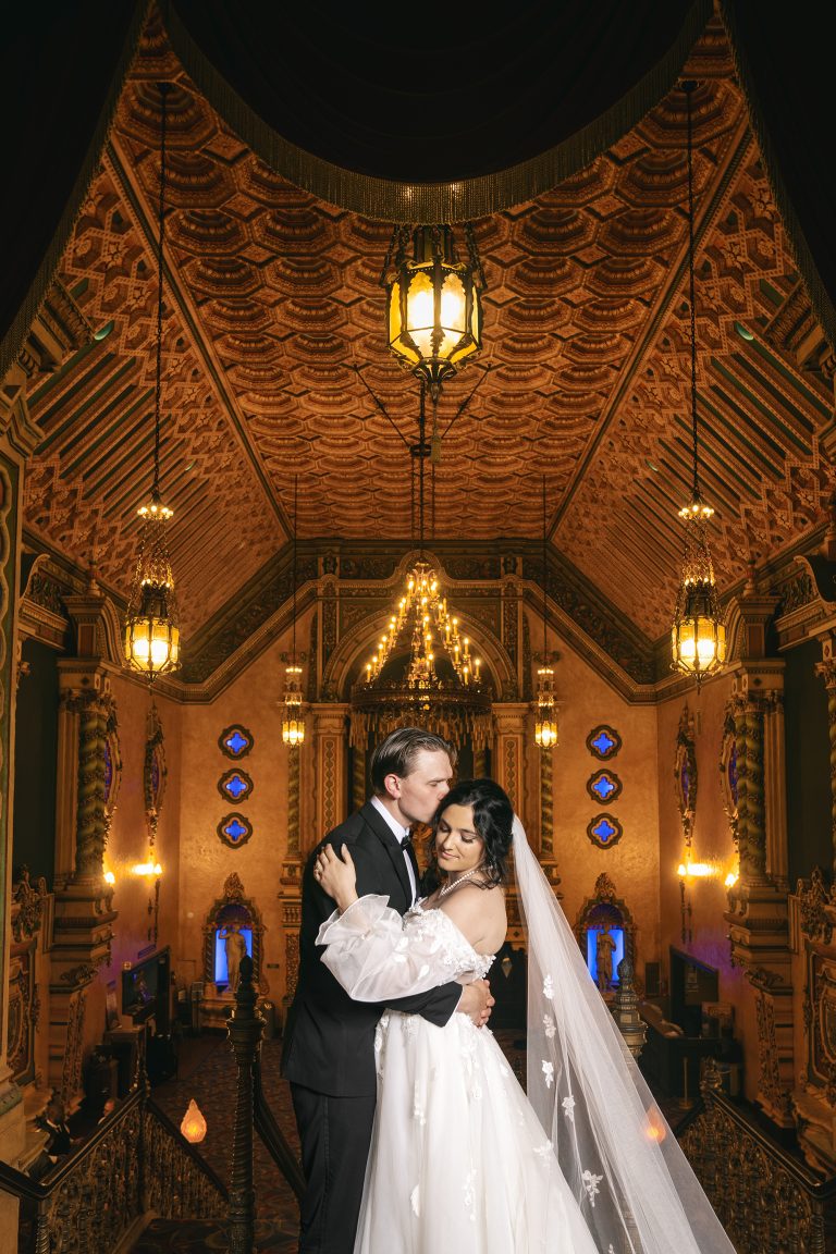 Bride and groom portrait in elegant church sanctuary with dramatic lighting