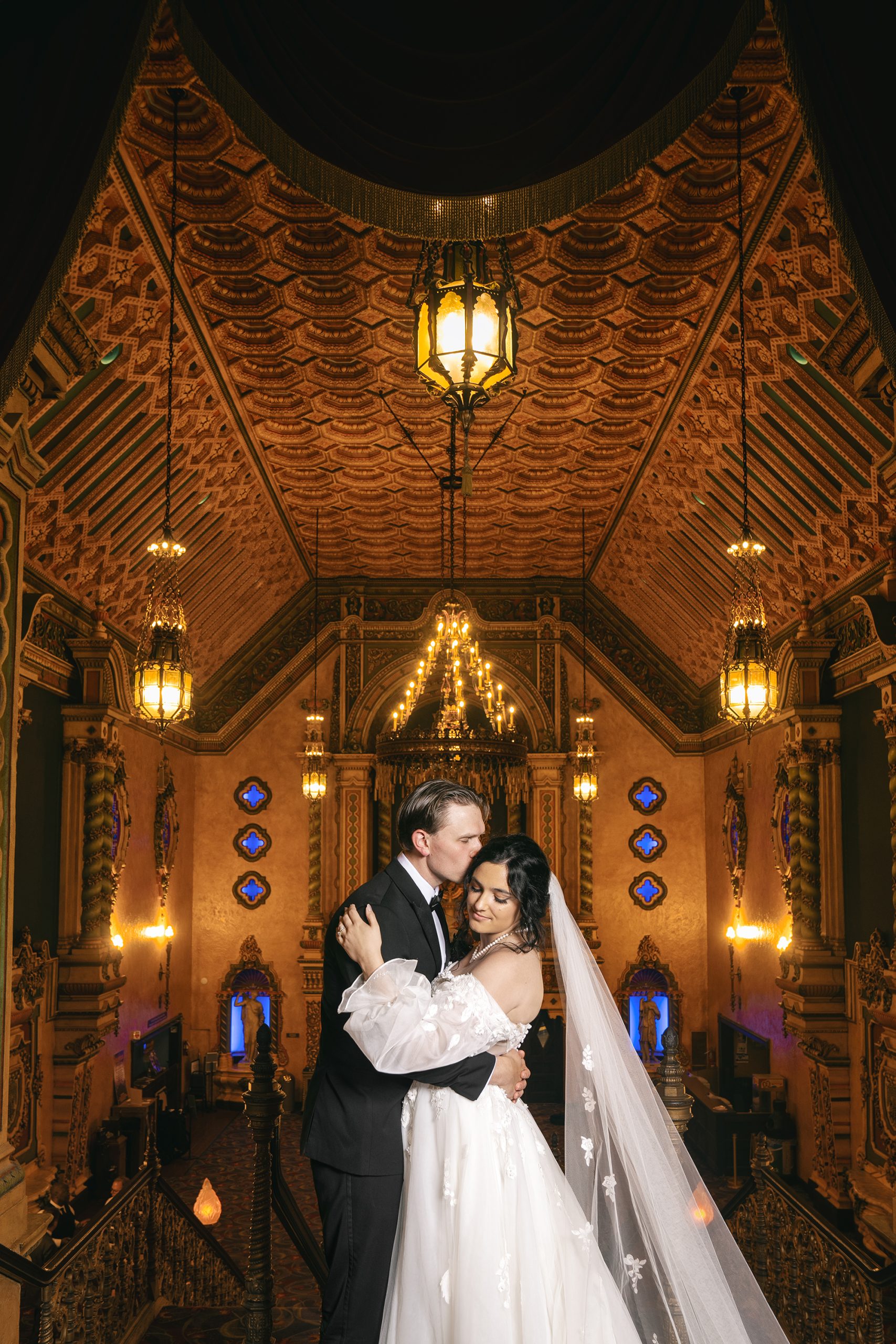 Bride and groom portrait in elegant church sanctuary with dramatic lighting