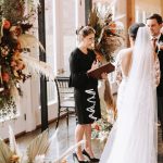 Bride in white gown during Persian wedding ceremony with bridesmaids and officiant