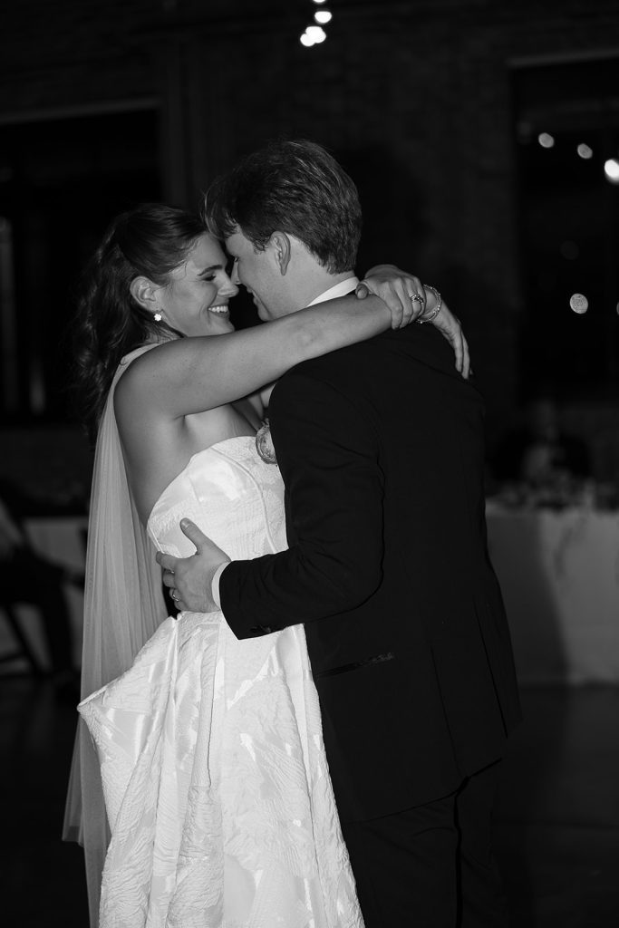 Caroline and Josh share their first dance as newlyweds in an intimate embrace