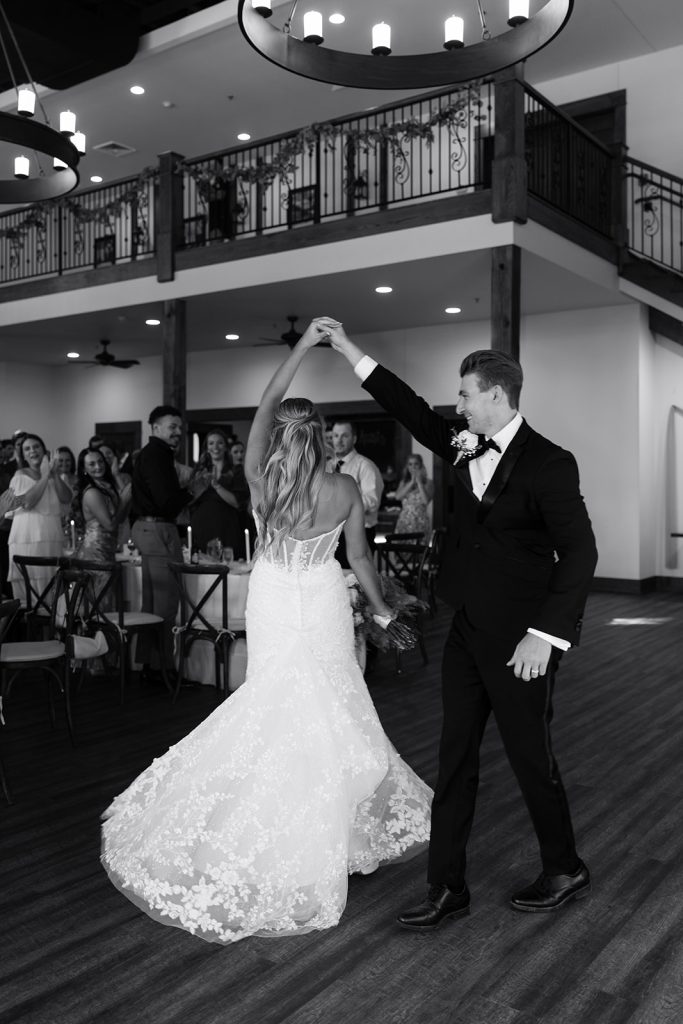 Rachel and Aaron share their first dance as guests watch from balcony above the reception hall