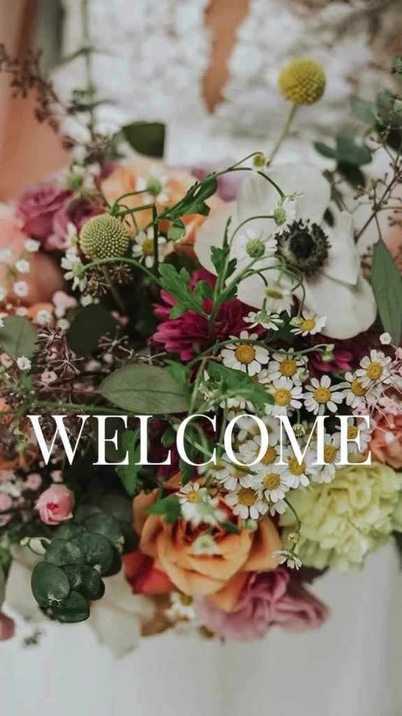 Wildflower bridal bouquet with daisies, craspedia, burgundy dahlias, and roses for Denver wedding