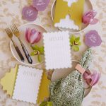 Elegant wedding table setting with Nebraska-shaped menu cards in chartreuse, scalloped place cards in lavender, and tulips with gold flatware