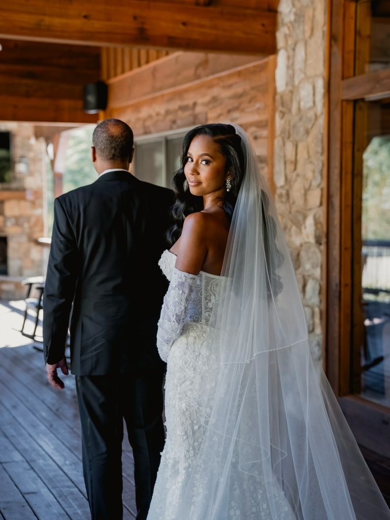 Bride and groom walking together at rustic venue with brick walls and exposed beams