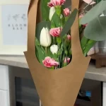 Pink and white tulips in decorative kraft paper cone sleeve tied with pink ribbon, a Perfect Petals Bloom Bar specialty