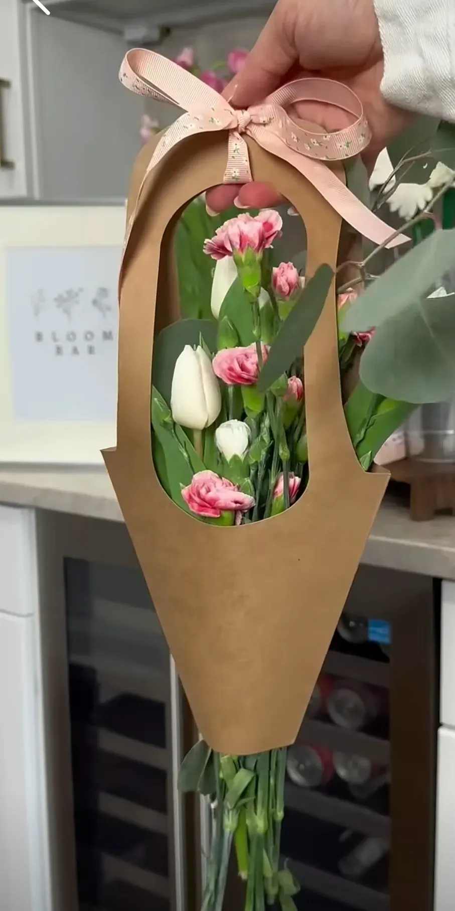 Pink and white tulips in decorative kraft paper cone sleeve tied with pink ribbon, a Perfect Petals Bloom Bar specialty