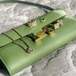 Diamond rings and jewelry displayed on green leather jewelry case with decorative fabric background