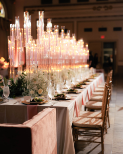 Candlelit wedding reception design with long tables, glass candle columns by Sage Hill Rentals, and elegant floral arrangements at The Westin Great Southern Columbus.