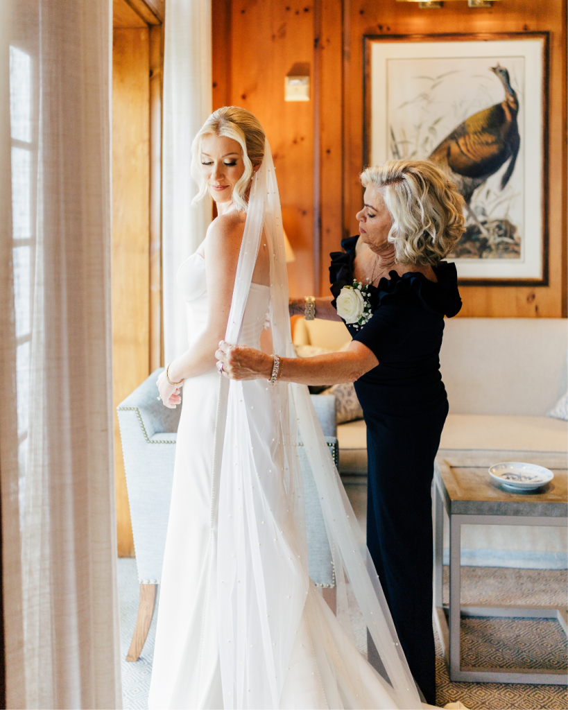 Bride Megan getting ready with her veil and gown inside Quail Hollow Clubhouse before her Charlotte country club wedding