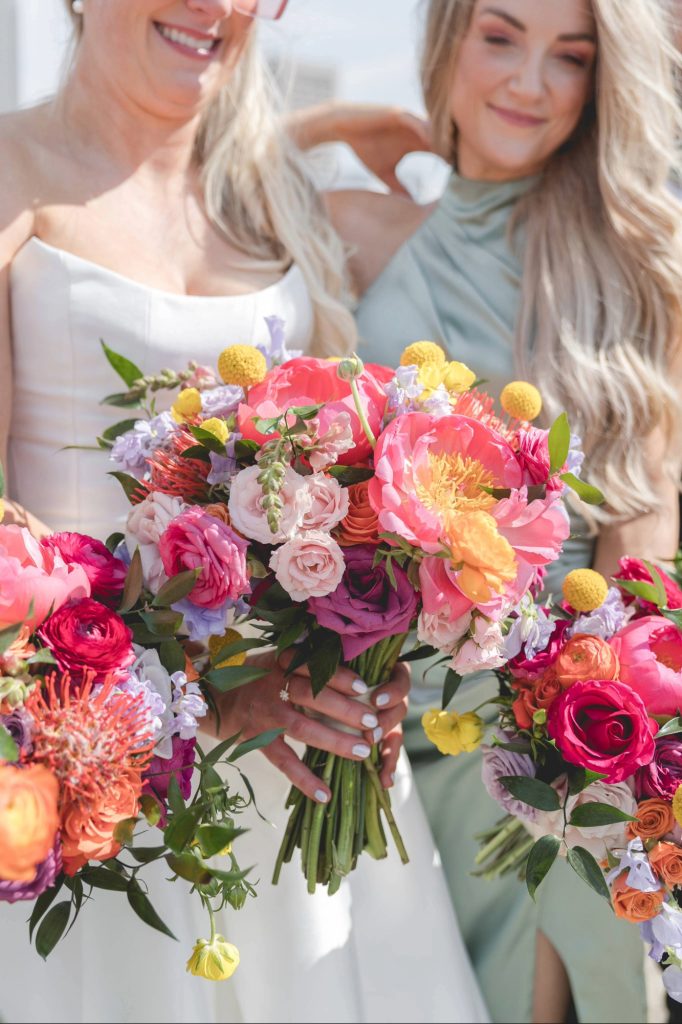 Bridal party holding bright pink bouquets during elegant Akron Ohio wedding photographed by a luxury Akron wedding photographer.