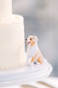 White wedding cake with dog figurine
