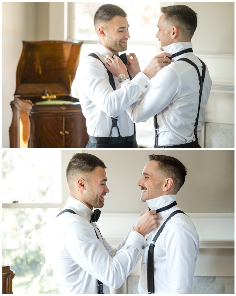 Two grooms help each other adjust bow ties and suspenders while getting ready on their wedding day.