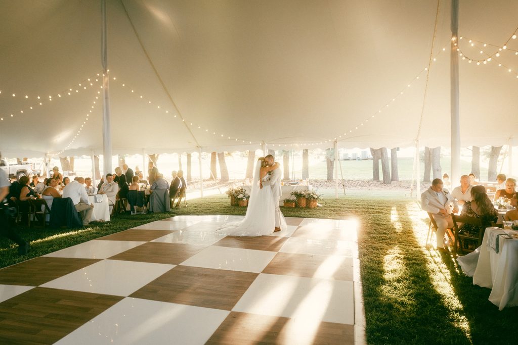 First dance under sailcloth tent with string lights at private property Eastern Shore wedding reception