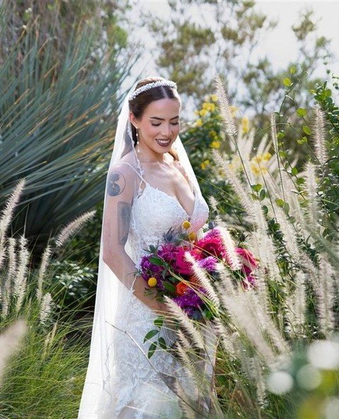 bride looking down at bouquet