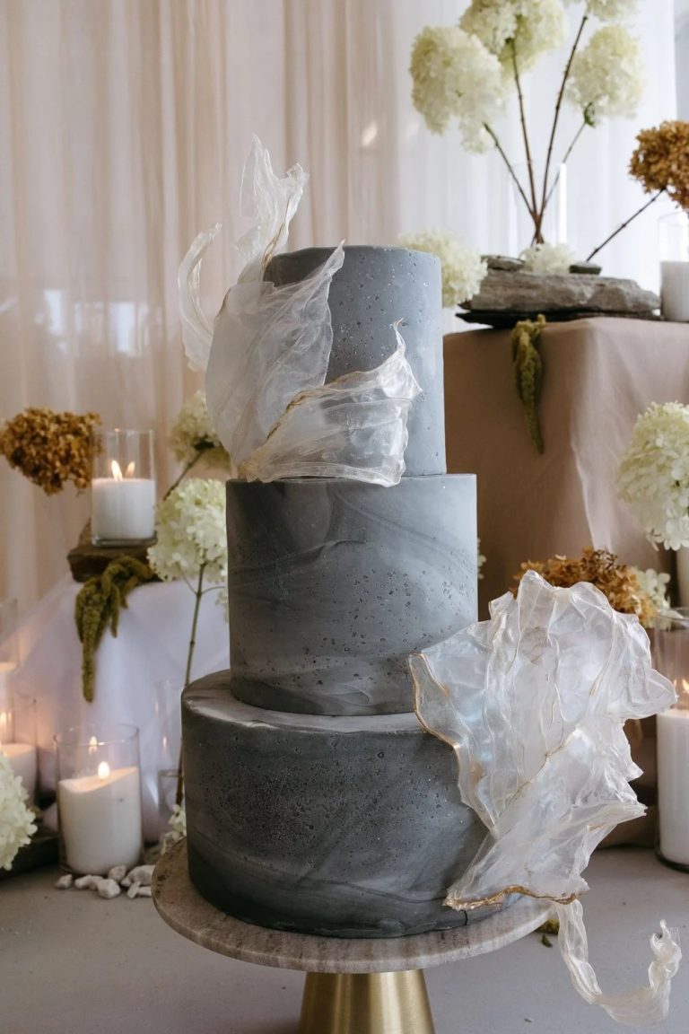 Three tier grey marbled wedding cake with white accents